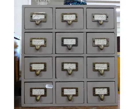 A table top painted pine cabinet of 12 small drawers