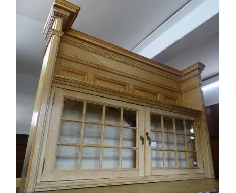 An Antique panelled and polished pine hanging cabinet, with 2 glazed doors, width 116 cm