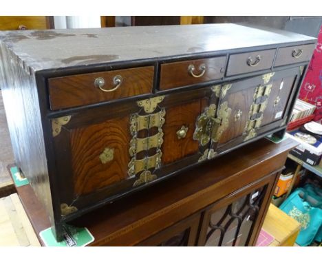 A small Chinese elm table top cabinet with fitted drawers and cupboards, with stylised brass mounts, width 88cm.