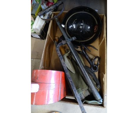 A Second World War fireman's equipment - tin helmet, axe, stirrup pump, trenching tool and a road lamp