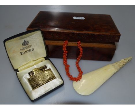 A carved ivory shoehorn, coral necklace, lighter etc