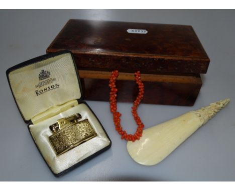 A carved ivory shoehorn, coral necklace, lighter etc