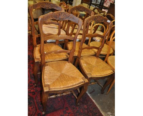 A set of 4 French oak ladder-back dining chairs