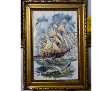 A gilt-framed tile picture