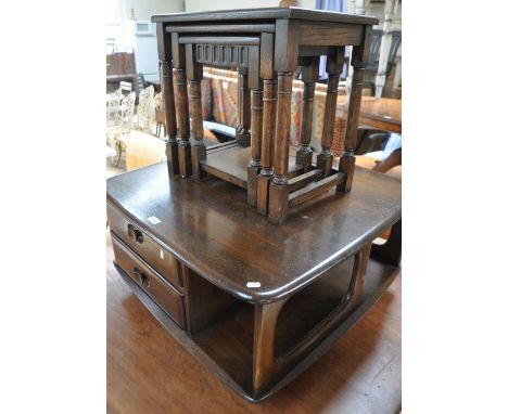 An Ercol stained elm revolving coffee table with fitted drawers, width 78 cm, together with a nest of 3 oak occasional tables