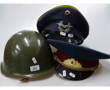 A military tin helmet and 2 Russian caps