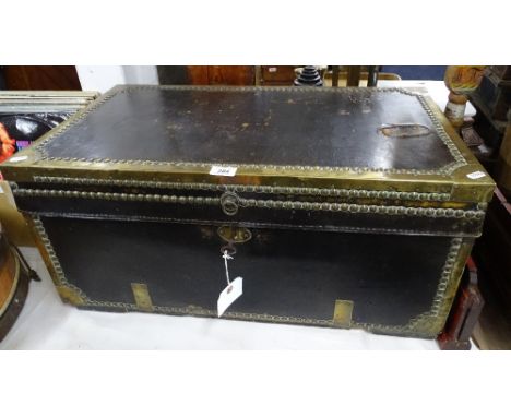 An Antique camphor wood brass-bound leather covered trunk, width 28.75"