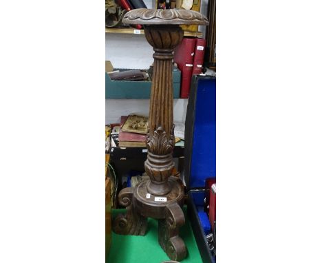 A carved-wood pricket candle stand on tripod base, height 29"