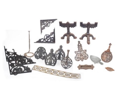 Five Arts &amp; Crafts cast iron pierced shelf brackets, together with an A. Kenrick &amp; Sons No. 8 cast iron trivet, 9" wi