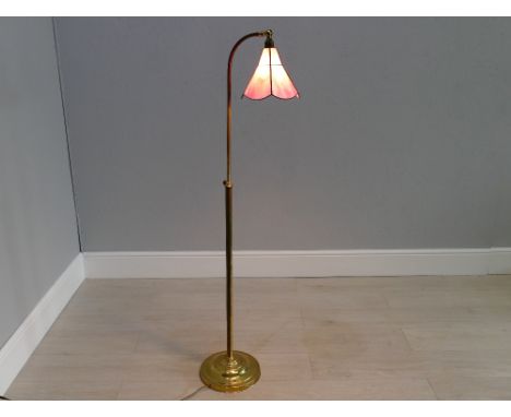 Adjustable brass floor lamp with Tiffany style glass shade, 56" tallshown in image to be functioning, will be sold without pl