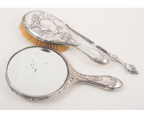 Edwardian silver mounted hand mirror, 28cm, dented; matching handbrush, together with a silver button hook.
