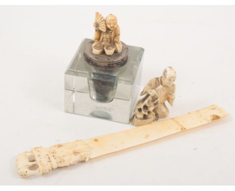 Glass and silver mounted inkwell, the lid with ivory netsuke, another netsuke and a letter knife. (3)