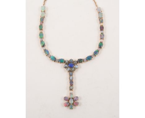 A "Lightning Ridge" black opal necklace, the yellow metal necklace marked 375 set with fifty stones, including seven cats eye