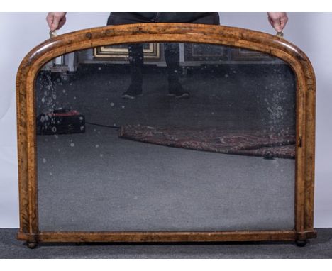 A Victorian walnut over mantle mirror, cavetto moulded frame, satinwood cross-banding and boxwood stringing, arched plate, wi