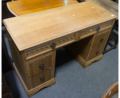 Oak desk, rectangular top, six drawers, bracket feet, carved decoration, width 118cm.