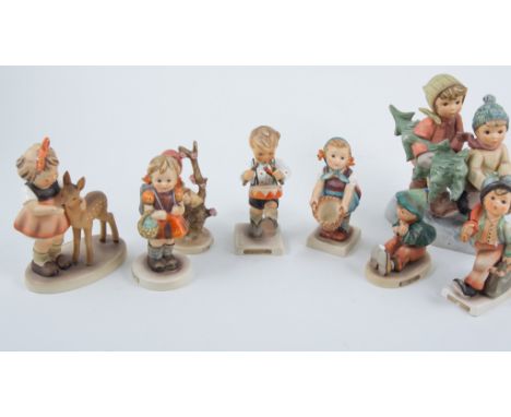 Fifteen Goebel Hummel figurines to include Apple Tree Boy and Apple Tree Girl, Soldier Boy, Be Patient, Friends, Little Goat 