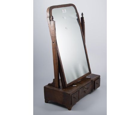 Walnut toilet mirror, 18th century and later, arched hinged plate, inverted break-front plinth, with three drawers, width 40c