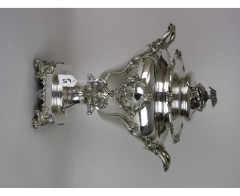 A plated Samovar with domed lid having leafage finial, two handles and body with leafage moulded decoration, panel with engra