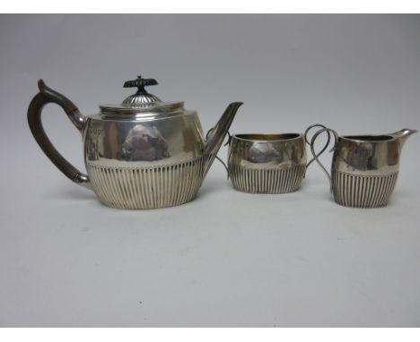 A Victorian silver three piece Tea Service of oval semi-fluted form, London 1891/2