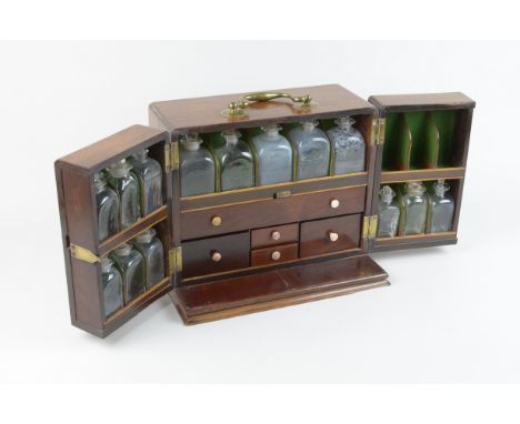 A Georgian mahogany Apothecary's Cabinet, fitted brass carrying handle, the interior fitted seventeen glass jar compartments,