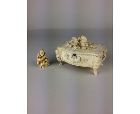 A 19th Century French ivory Casket, probably Dieppeof serpentine form, carved in high relief with flowers, putti scrolled leg