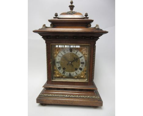 A Victorian Mantel Clock with square brass dial having silvered chapter ring and gilt spandrels, two train movement striking 