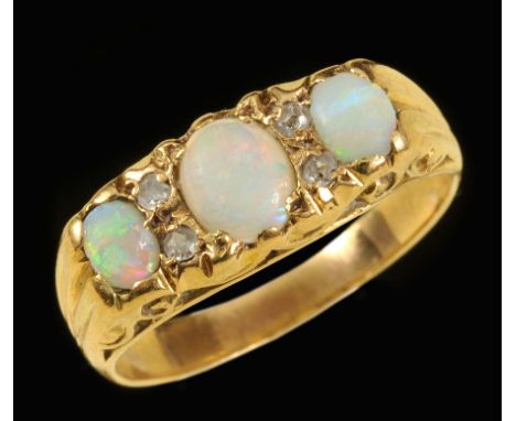 An Opal three stone Ring pavé-set graduated oval cabochons with rose-cut diamonds between, stamped 18ct, ring size P