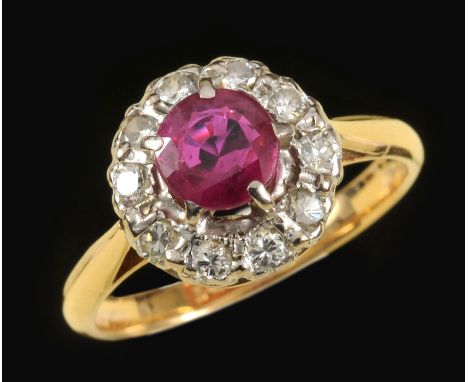 A Ruby and Diamond Cluster Ring claw-set circular-cut ruby within frame of brilliant-cut diamonds, stamped 18ct & PLAT, ring 