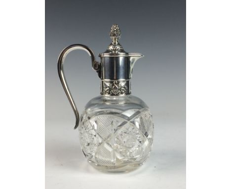 An early 20th Century Russian silver-mounted Decanter Jug, by Fabergé, the deeply cut glass spherical body with hinged cover 