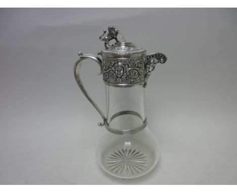 An Edward VII silver mounted cut glass Claret Jug with mask and fruiting vine frieze, mask spout, lion rampant and shield fin