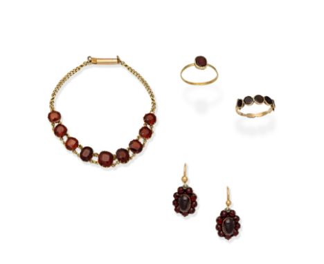 COLLECTION OF GARNET-SET JEWELLERY1st: Each earring set with an oval garnet cabochon within a surround of rose-cut garnets, 2