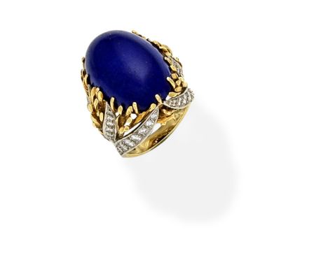 LAPIS LAZULI AND DIAMOND DRESS RING,  CIRCA 1975Set with a lapis lazuli cabochon within a bi-coloured tendril surround set wi