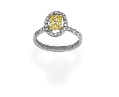 FANCY-COLOURED DIAMOND CLUSTER RINGThe oval-cut Fancy Intense Yellow diamond, weighing 0.82ct within a brilliant-cut diamond 