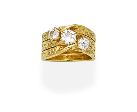 DIAMOND-SET RING, 1972Set with three old brilliant-cut diamonds, on an 18 carat gold textured hoop,  diamonds approx. 1.30cts