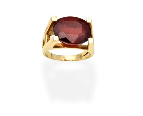 GARNET RINGSet with an oval-cut garnet,  ring size approx. PFor further information on this lot please visit Bonhams.com