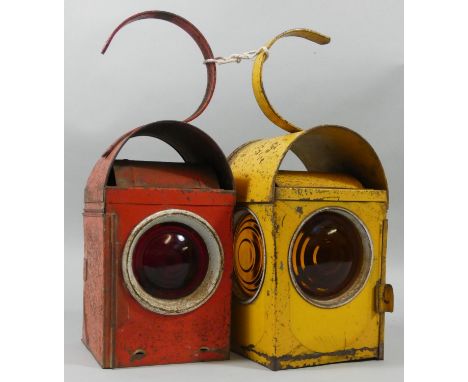 A red paraffin road lamp and a yellow example (2). 