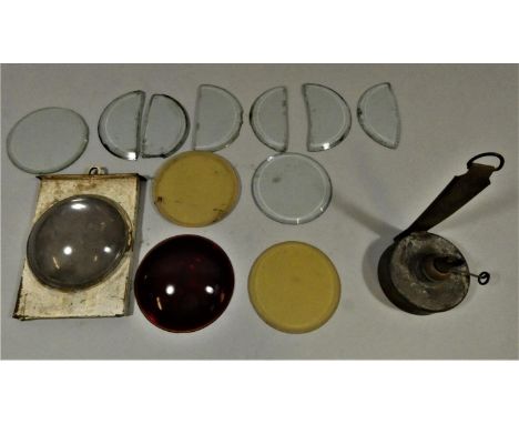 A quantity of clear and red lenses for hand and side lamps, a spare lamp reservoir and other items. 