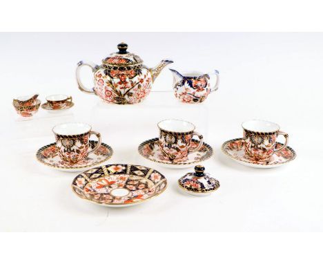 A small group of Royal Crown Derby Imari pattern tea wares to include teapot, cups &amp; saucers and miniatures.