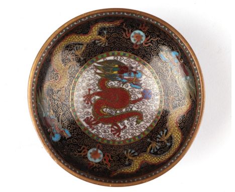 A finely detailed Chinese cloisonne bowl decorated with dragons chasing a flaming pearl, on a black ground, 8cms diameter.