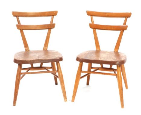 A pair of Ercol mid-century Yellow Dot children's stacking chairs (2).