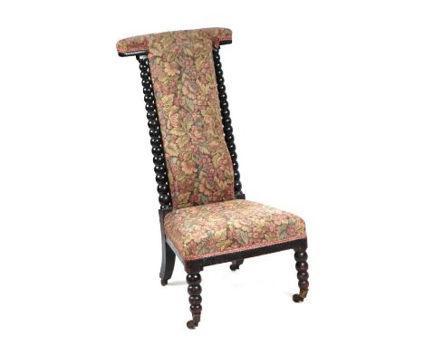 A Victorian Prie Dieu chair with upholstered seat and back and ebonised bobbin turnings.