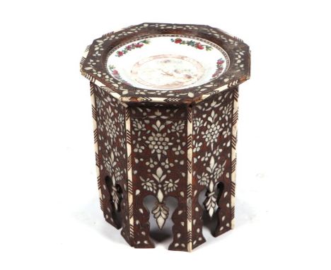 An Islamic / Moorish side table with mother of pearl and bone inlaid decoration, the top inset with a French porcelain plate,