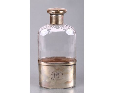 A George V silver and glass hip flask retailed by Finnigan's Ltd, Manchester, 16cms high.