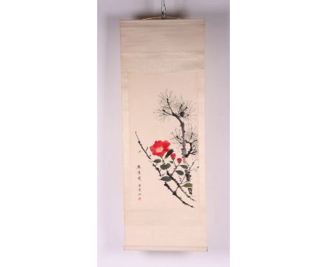 A Chinese scroll painting depicting flowers and a fir tree with calligraphy, 33 by 66cms.