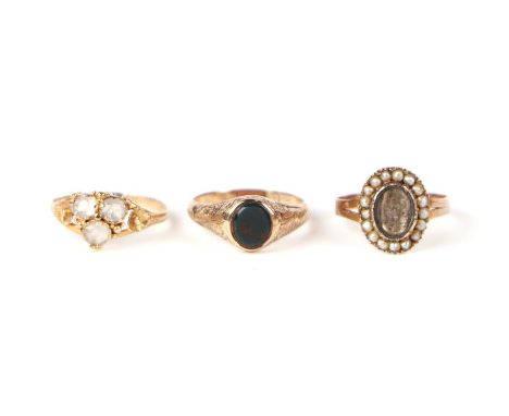 A 19th century yellow metal and bloodstone ring, approx UK size 'K'; together with two other yellow metal rings, 4g (3).
