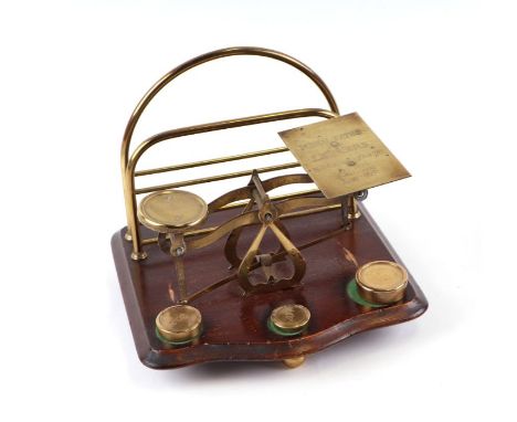 A set of brass postal scales and combination letter rack, 21cms wide.