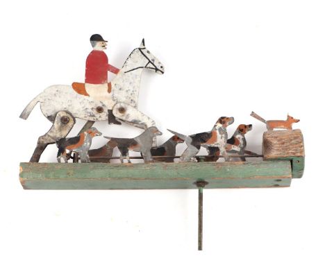 A painted metal and wooden Folk Art garden windmill depicting huntsmen and hounds, 41cms long.Condition ReportMissing the bla