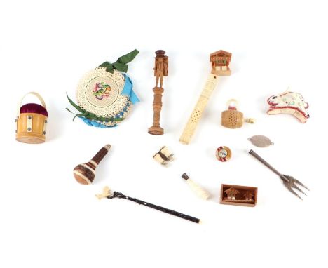 A group of sewing related items to include a Victorian pin cushion in the form of a bucket, a Black Forest figural needle cas