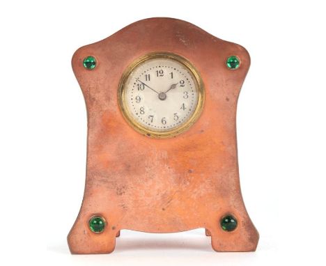 An Arts &amp; Crafts copper mantle alarm clock with inset green glass cabochons, 10cms high.
