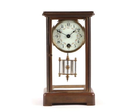 A French style mantle clock, the white porcelain dial with Arabic numerals, fitted with a 30-hour movement with mercury pendu